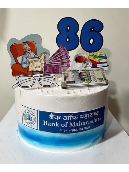 A special cake for a grandfather's 86th birthday, celebrating his career at Bank of Maharashtra. The vanilla strawberry cake is decorated with toppers representing his retirement hobbies.