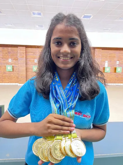 Supriya, one of our star athletes, with the eight gold medals she won at the 11th Karnataka State Shooting Competition. An absolutely phenomenal performance.