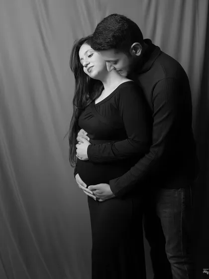 An intimate embrace captured in classic monochrome. This pose emphasizes the closeness and affection between the couple during this special time.