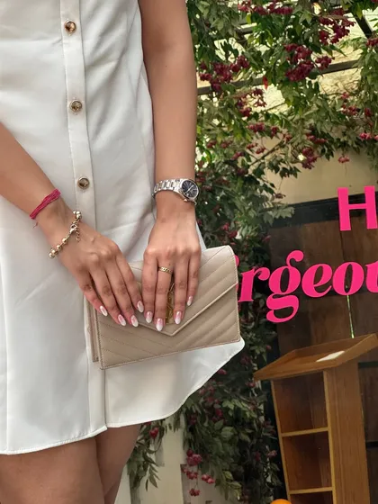 A close-up on the accessories. I paired the white dress with a classic YSL bag, showing how a luxury piece can elevate an affordable outfit.