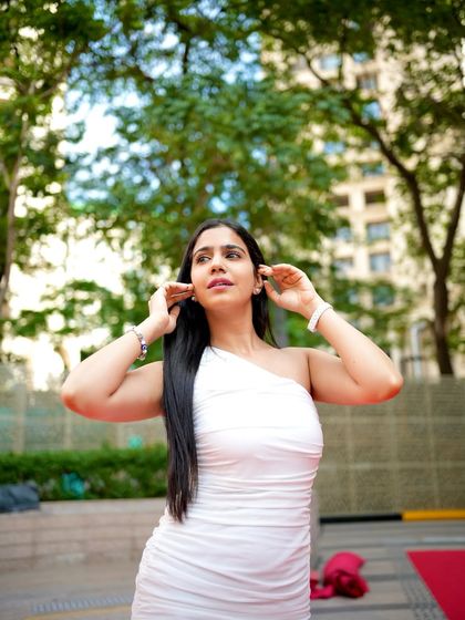 A candid-style shot, adjusting my hair. This adds a touch of natural charm to the polished look.