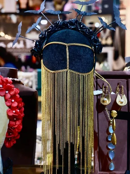 This is for the ones who dare to be different. This avant-garde headpiece with its intricate golden chains and bat-wing details is the ultimate statement piece. It’s proof that we don’t do cookie-cutter accessories; we create wearable art.