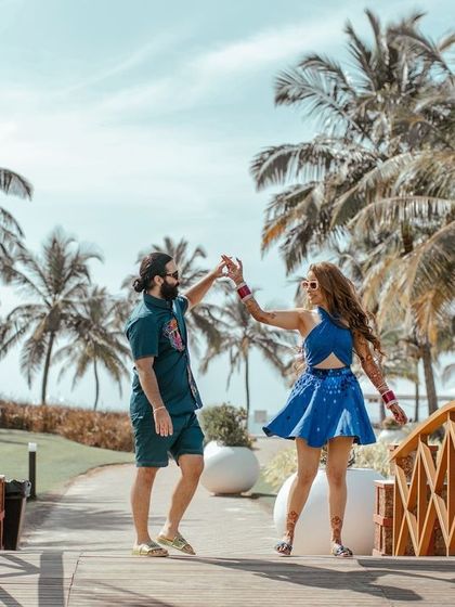 A playful dance on a bridge in Goa. We capture the fun and carefree spirit of a couple's pre wedding celebration in a beautiful, tropical setting.