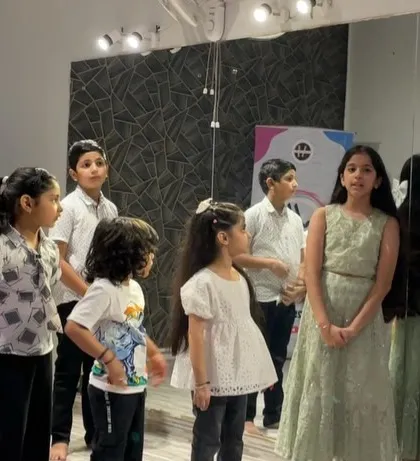 A quiet moment before the big performance at our summer camp finale. The kids are all dressed up and ready to show their parents what they've learned.