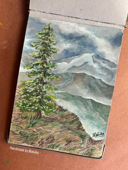 This sketchbook view shows my watercolor painting of a lone pine tree against a dramatic, cloudy mountain range. It captures the feeling of solitude and the raw beauty of nature.