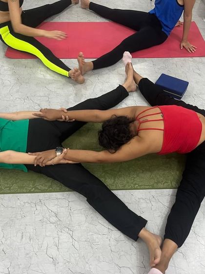 Partner stretches, like this assisted forward bend, allow for a deeper release than one can often achieve alone.