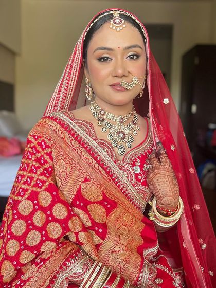The final bridal look for Kritika. She is the epitome of a classic Indian bride, with radiant makeup that enhances her natural beauty.
