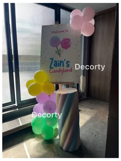 A welcome sign for "Zain's Candyland," featuring a marshmallow-themed pedestal.