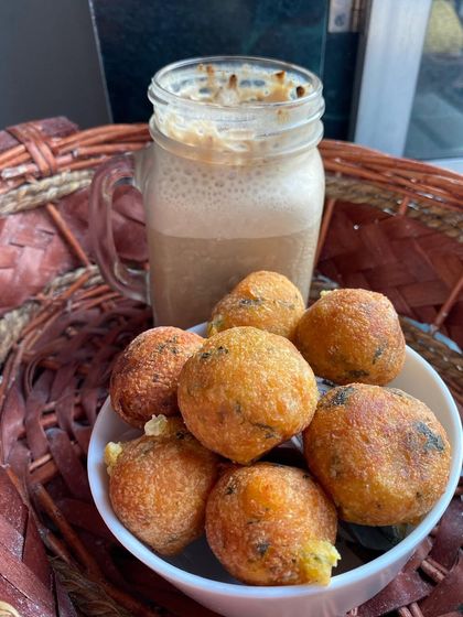 Our Cheese Corn Balls are a party favorite, especially with kids. They have a crispy exterior and a warm, gooey center filled with melted cheese and sweet corn. We serve them hot for the best experience.