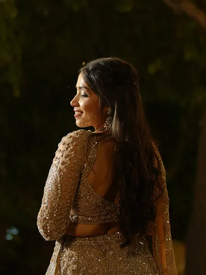 A beautiful profile shot showcasing her soft waves and the radiant glow of her skin.
