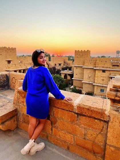 Watching the sunset over Jaisalmer fort. The vibrant blue of my dress created a stunning contrast with the warm colors of the sunset.
