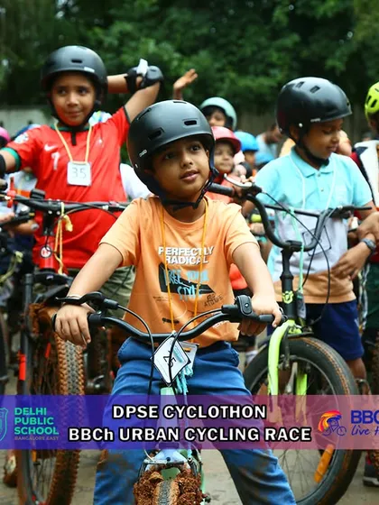 A group of young cyclists, helmets on and ready, wait for the race to begin. The camaraderie among these young riders is fantastic to witness.