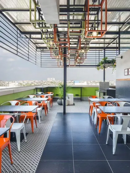 An office rooftop cafeteria with a view. I designed this space to be an escape from the daily grind, using bright, industrial-style furniture and an open-air layout to create a relaxed atmosphere for coffee breaks and informal meetings.