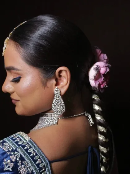A side view highlighting the elegant updo and glowing cheekbones.