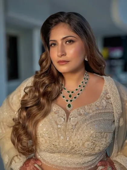 A powerful portrait of the bride, ready for her reception. The makeup is elegant and complements her emerald jewelry perfectly.