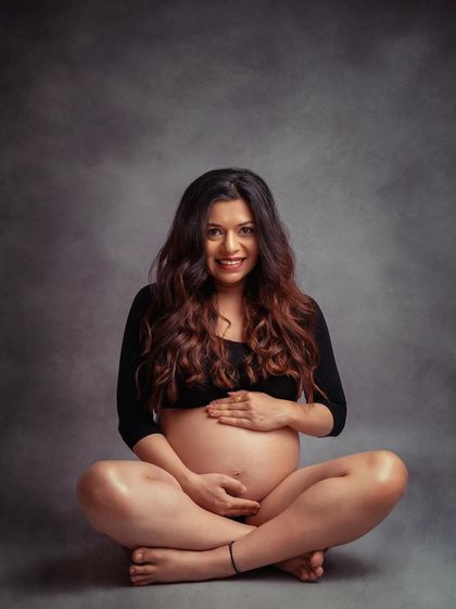 A happy and relaxed bare-bump portrait. This simple, seated pose is a beautiful way to celebrate your changing body.