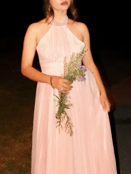 A close-up on the bodice of the dress and the flowers.