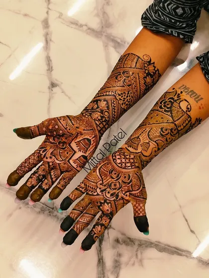 A rich and dense Indian design covering the hands and arms. The mix of geometric and floral patterns creates a stunning and traditional effect.