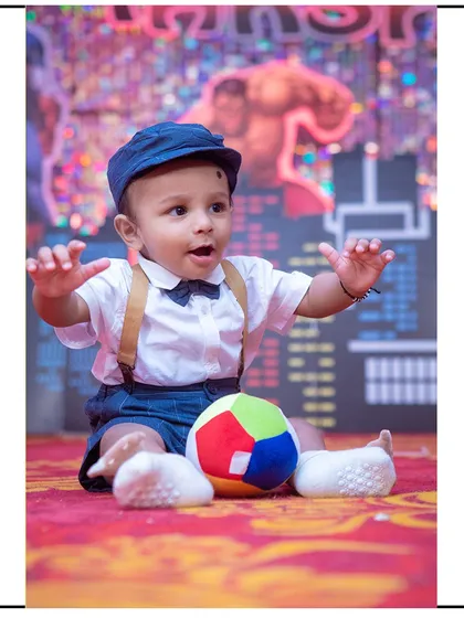 An action shot of a toddler playing with a soft ball during his studio session. I use age-appropriate toys to keep children engaged and happy.