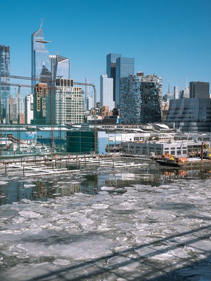 Another perspective of the ice on the Hudson, this time looking towards Hudson Yards. The reflections and textures of the ice and buildings create a cold, geometric composition.