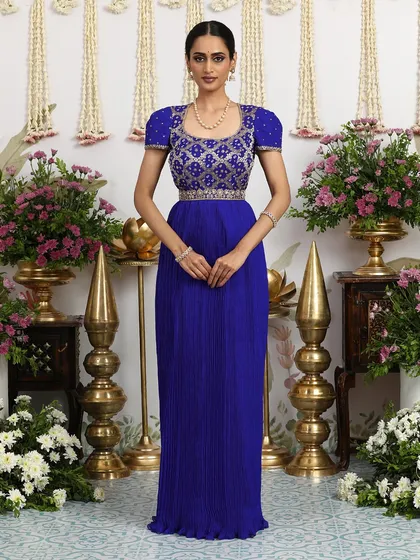 The standing pose highlights the beautiful drape of the pleated skirt and the regal color of the gown.
