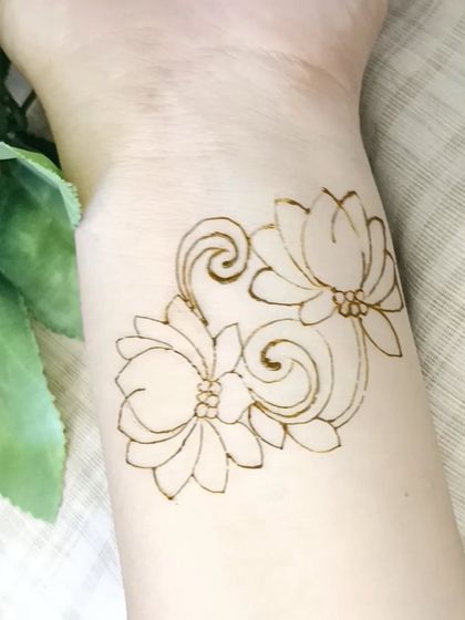 A simple and elegant lotus patch design, shown here in its initial outline phase on the wrist.