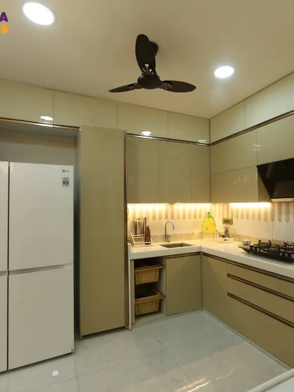 A view of the kitchen's cooking area, with a built-in hob, chimney, and plenty of storage. The under-cabinet lighting provides excellent task lighting.