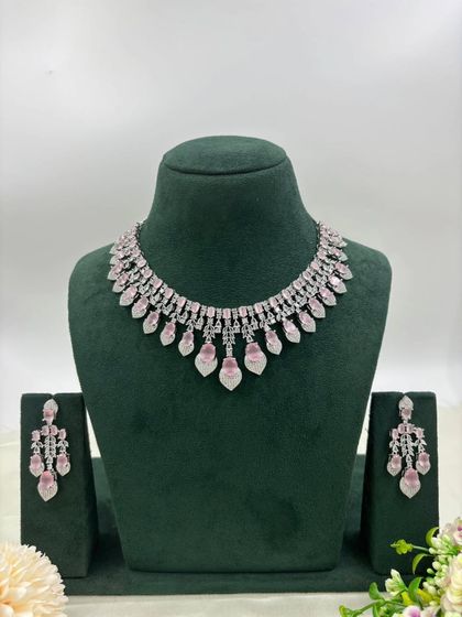 A delicate silver-plated AD necklace with a fringe of leaf-shaped stones. This design is available in mint green, white, and a two-tone pink and green, offering a fresh and modern aesthetic.