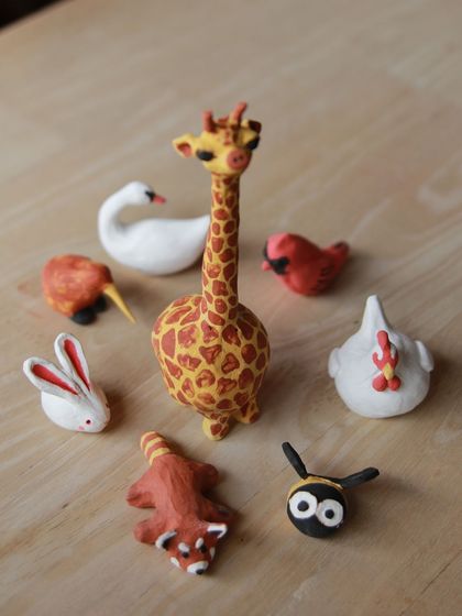 A collection of miniature animals created in our workshops, including a giraffe, swan, and red panda, showcasing the fun and creativity of the sessions.