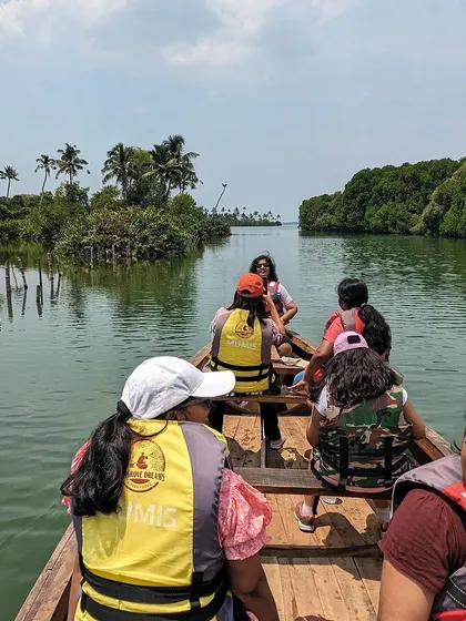 A group enjoying a boat ride in the backwaters of Alleppey, Kerala.