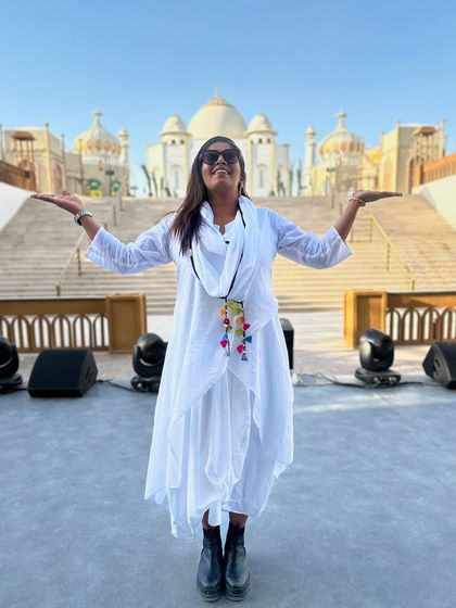 Arms wide open, embracing the blessings and guidance from the universe. Standing on our stage in Riyadh, I am filled with gratitude for my team's hard work and the success of our show.