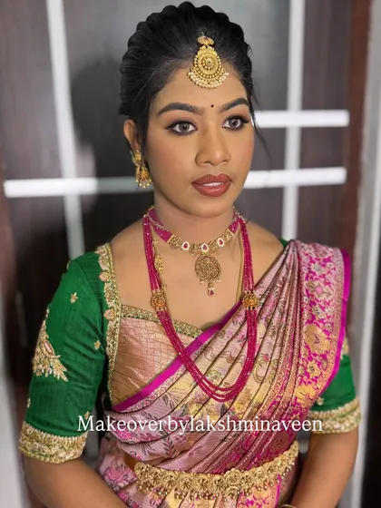 A close-up of the makeup for the pink and green half-saree look, featuring soft eyes and a matching lip color.