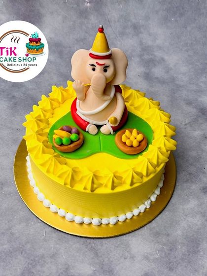 A bright yellow cake for Ganesh Chaturthi, topped with a handcrafted, edible Ganesha idol. This cake is made with love and devotion for your festive celebrations.
