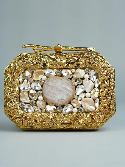 A duplicate of the hero image, this handcrafted brass clutch showcases a textured gold finish and a beautiful arrangement of natural stones. It's a perfect example of the premium, one-of-a-kind accessories I curate.