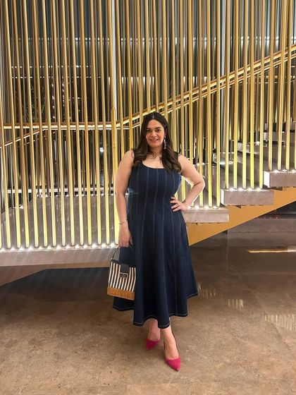 I love a versatile piece. I've styled this denim dress from 22.11 in multiple ways, and here I paired it with hot pink pumps and a striped Kate Spade bag for a fun, color-popped look.