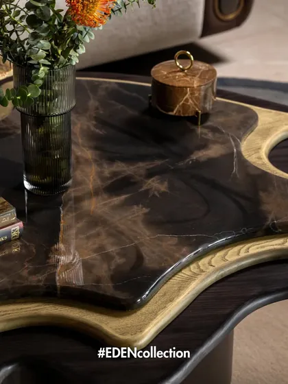 The Eden Collection is about bringing warmth and texture into a space. This shot details a custom coffee table with a unique resin and wood top, designed to be both a functional surface and a piece of abstract art.