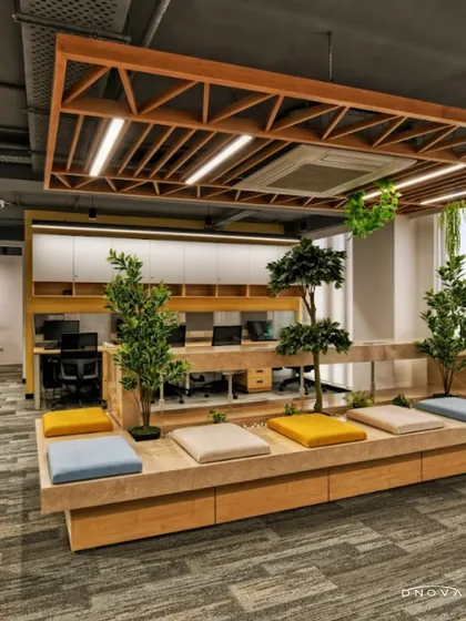 This breakout area at the Shailja Papers office, a design and build project, incorporates biophilic design to promote well-being. The tiered seating with integrated planters creates a space for informal meetings and relaxation, bringing a touch of nature into the workday.