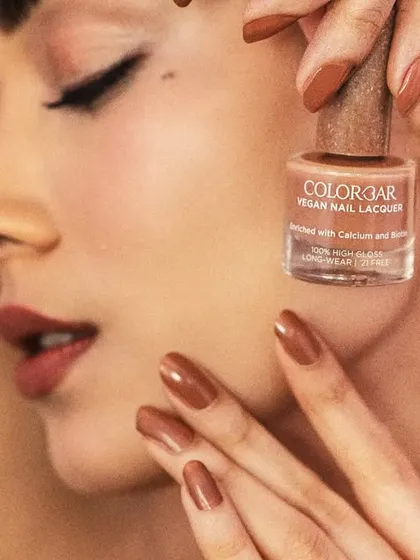 A detailed macro shot for Colorbar, focusing on the texture and finish of the vegan nail lacquer. This is where precision lighting is key.
