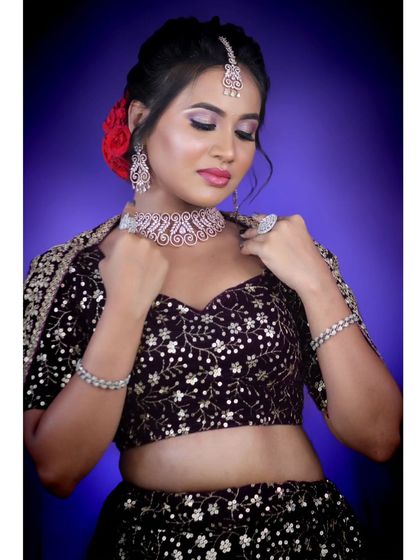 A glamorous reception look with a purple velvet lehenga, complemented by our sparkling diamond-look choker set.