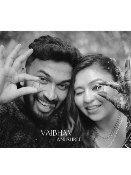 A fun and playful black and white shot of the newly engaged couple showing off their rings. The monochrome format emphasizes their joyful expressions.