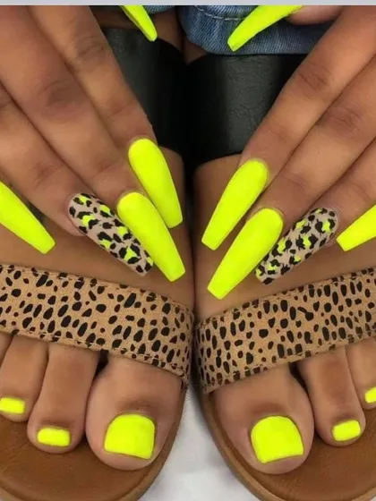 A bold and coordinated look with neon yellow nails and leopard print accents, matching the pedicure and even the client's sandals.