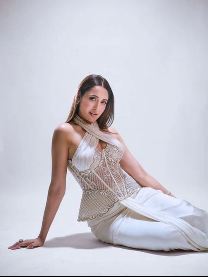 Pragya Jaiswal in a signature look from the 'Prismatic Symphony' collection, featuring an intricately embroidered corset with a peplum detail and a halter neckline.