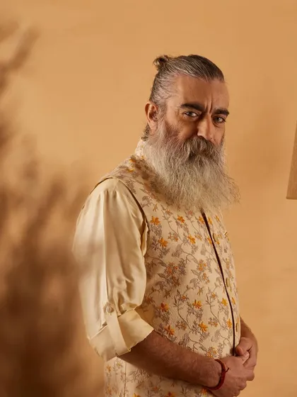 This floral printed vest in neutral tones offers a sophisticated yet relaxed look. It's a versatile piece that can be dressed up or down for any semi-formal occasion.