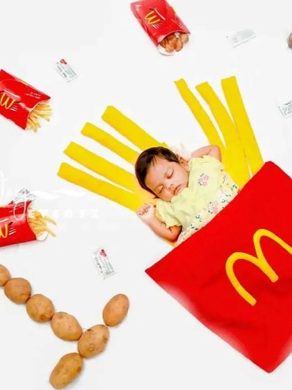 Looking for a fun and quirky newborn photoshoot idea? We love getting creative with unique concepts like this McDonald's fries theme. It's a playful and memorable way to announce your little one's arrival.