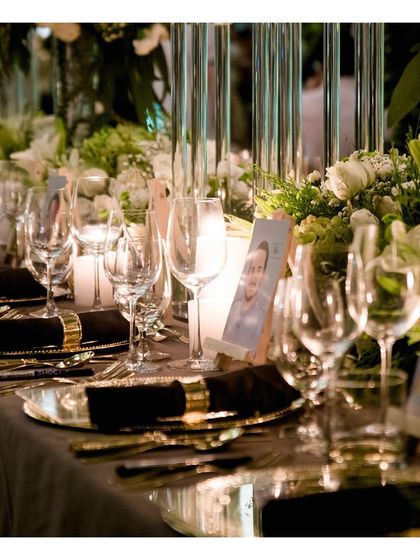 A detailed view of a place setting with personalized photo cards for guests. We seamlessly collaborate with event planners to incorporate personal touches into our service, making the experience unique to the hosts.