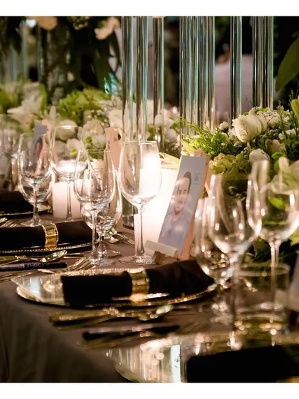 A detailed view of a place setting with personalized photo cards for guests. We seamlessly collaborate with event planners to incorporate personal touches into our service, making the experience unique to the hosts.