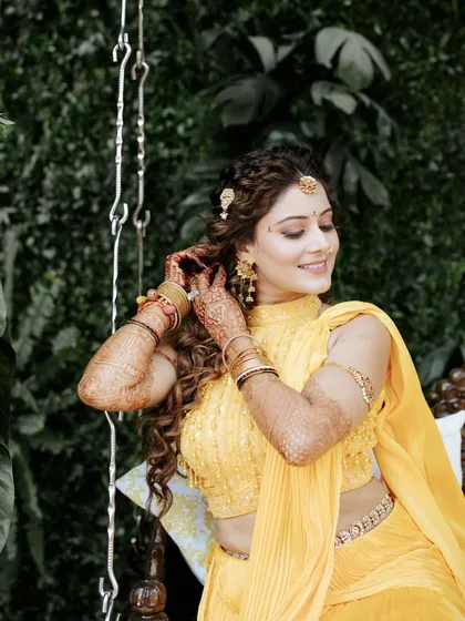 A close-up of the bride's detailed Haldi look, from her floral-inspired hairstyle to her delicate jewellery.