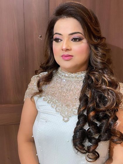 An elegant hairstyle for a special occasion. The voluminous curls and soft makeup create a look of timeless beauty.