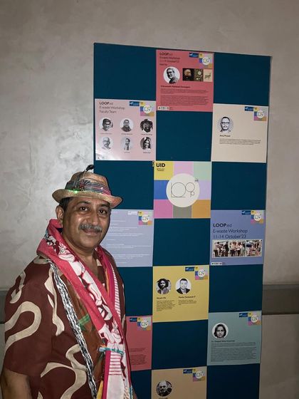 At the Unitedworld Institute of Design (UID) event, standing by a board detailing the workshop's goals.