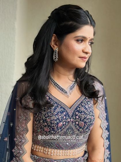 A soft and pretty look for a sangeet night. This client's features are enhanced with subtle contouring, defined eyes, and a half-up hairstyle with gentle waves.